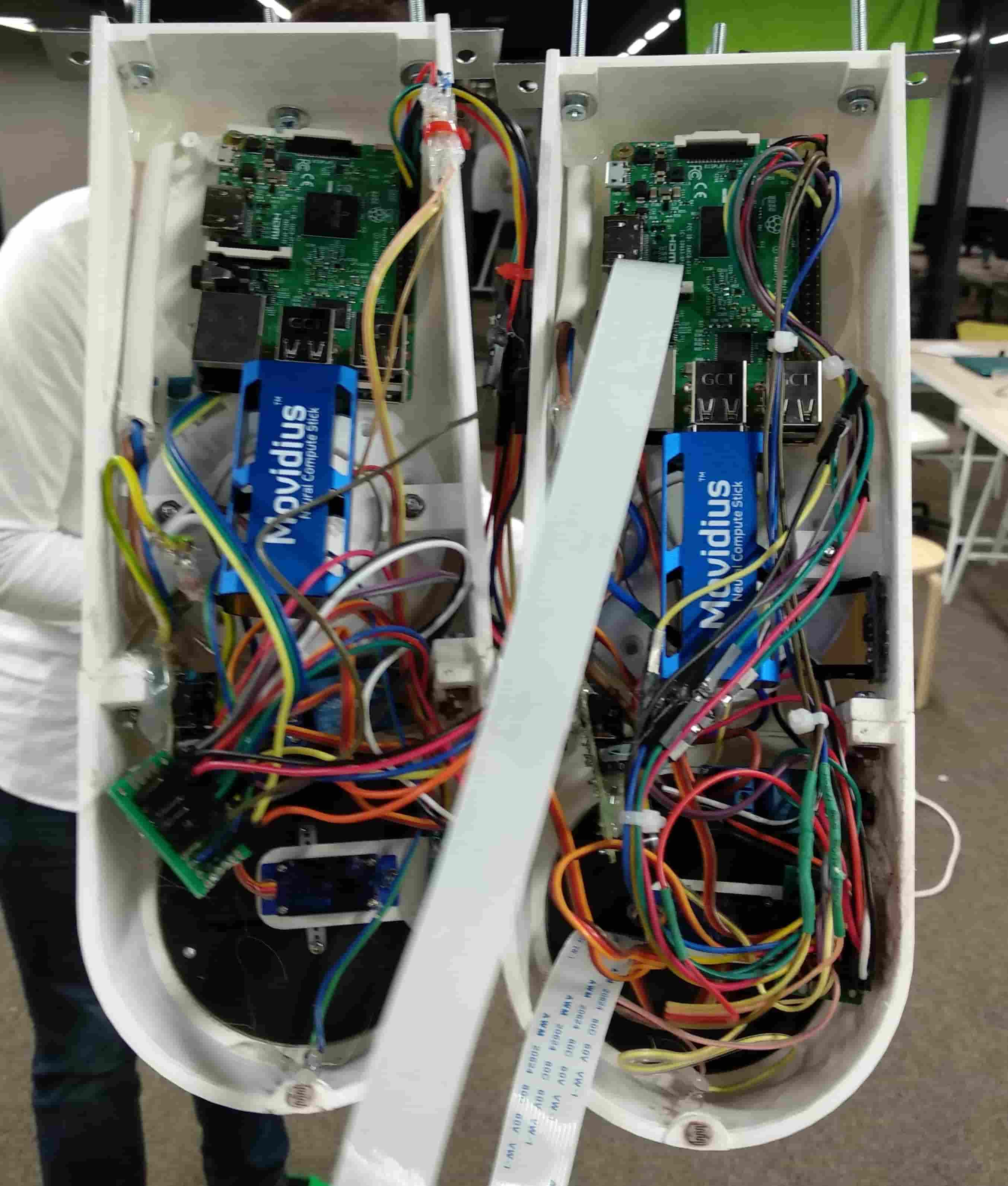 Inside view of two assembled stations, showing the Raspberry Pi boards, Movidius compute sticks, and wiring